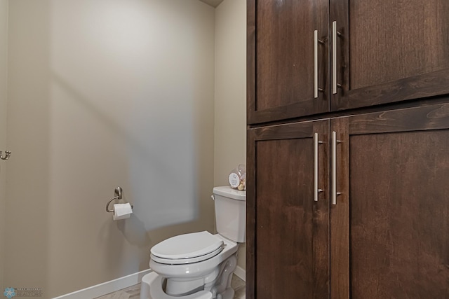 bathroom featuring toilet and tile floors