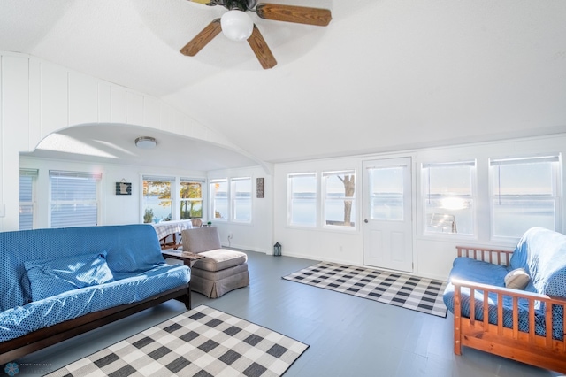 living room featuring hardwood / wood-style floors, vaulted ceiling, and ceiling fan