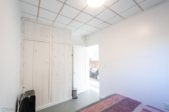 unfurnished bedroom featuring a closet and a paneled ceiling