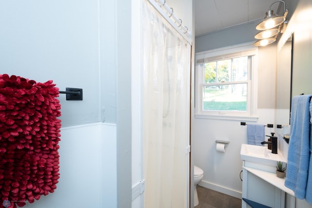 bathroom with vanity with extensive cabinet space and toilet