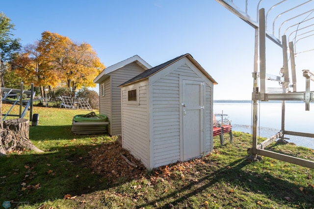 view of shed / structure featuring a water view and a lawn