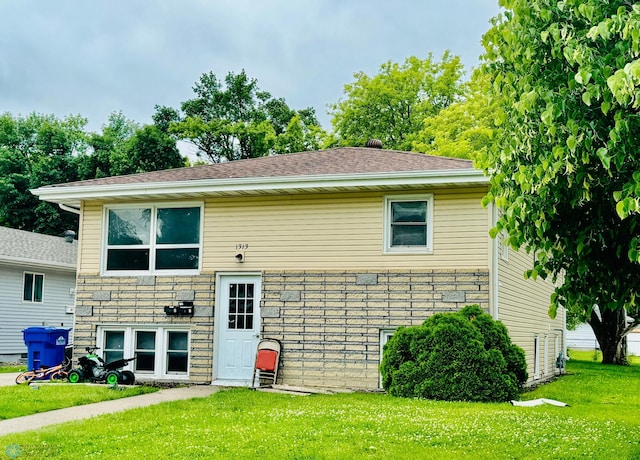 raised ranch with a front lawn