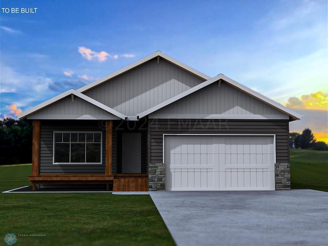 view of front of property featuring a garage and a lawn