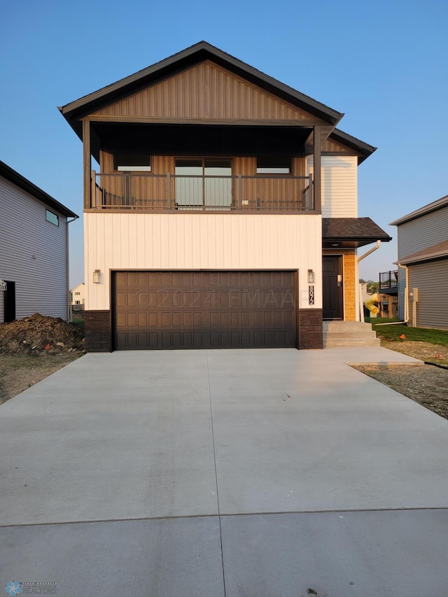 view of front of property with a balcony and a garage