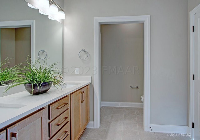 bathroom with dual bowl vanity, toilet, and tile flooring