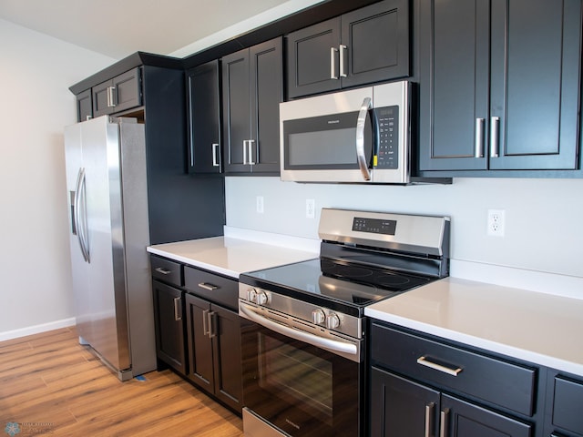 kitchen featuring appliances with stainless steel finishes and light hardwood / wood-style floors