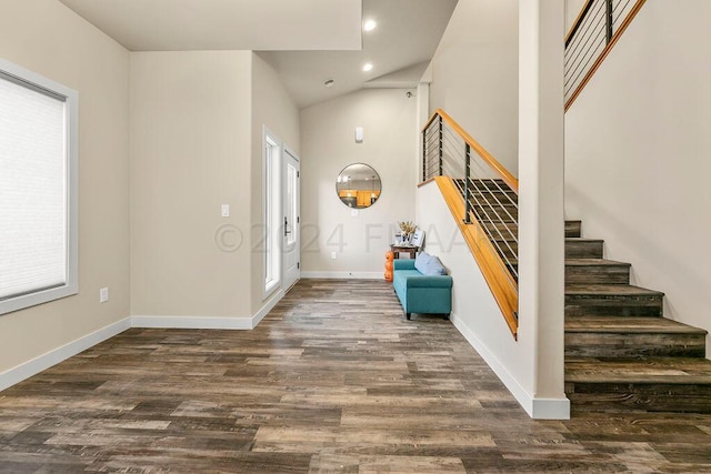 entrance foyer featuring dark wood-type flooring and vaulted ceiling