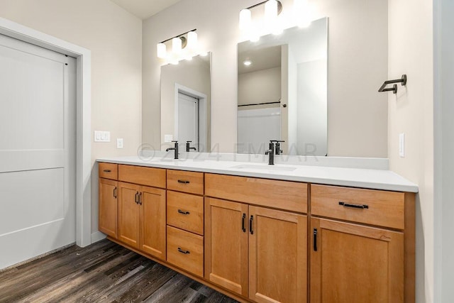 bathroom featuring double vanity and hardwood / wood-style floors