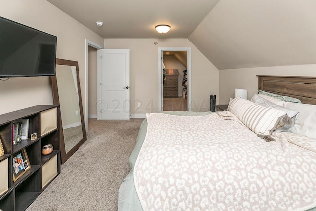 carpeted bedroom featuring lofted ceiling