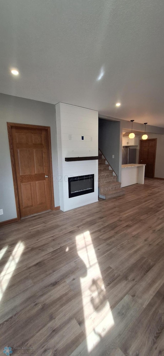 unfurnished living room featuring hardwood / wood-style flooring