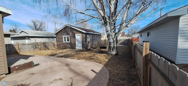 view of yard with an outbuilding and a patio area