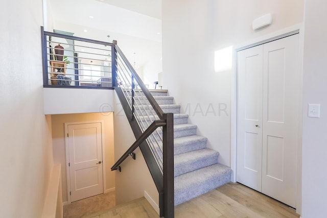 stairs featuring light wood-type flooring