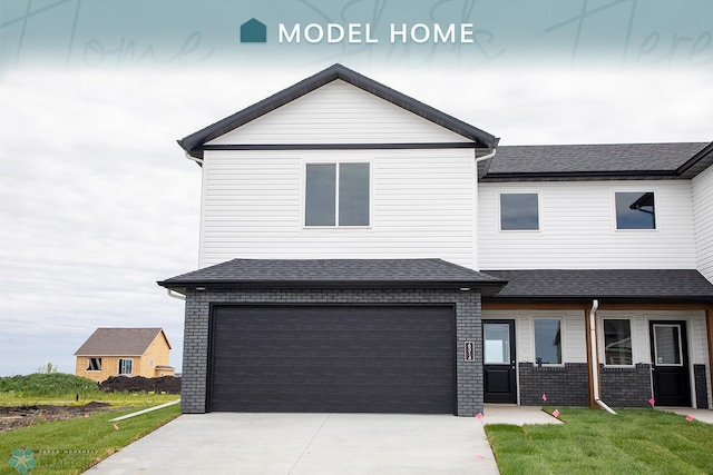 view of front of property with a garage and a front lawn