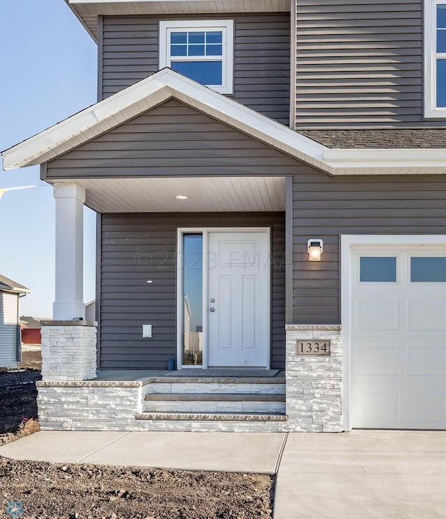 view of exterior entry with a garage