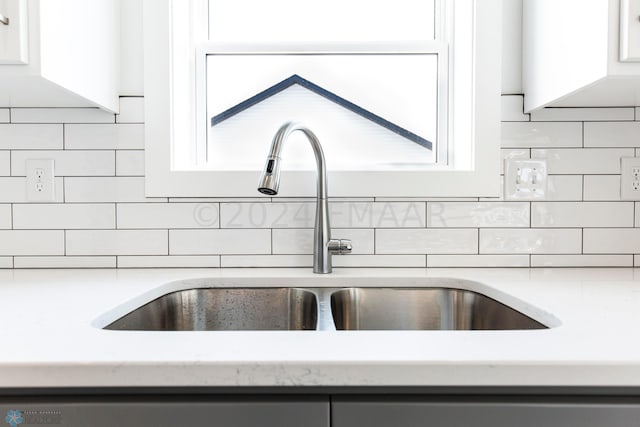 interior details featuring tasteful backsplash and sink