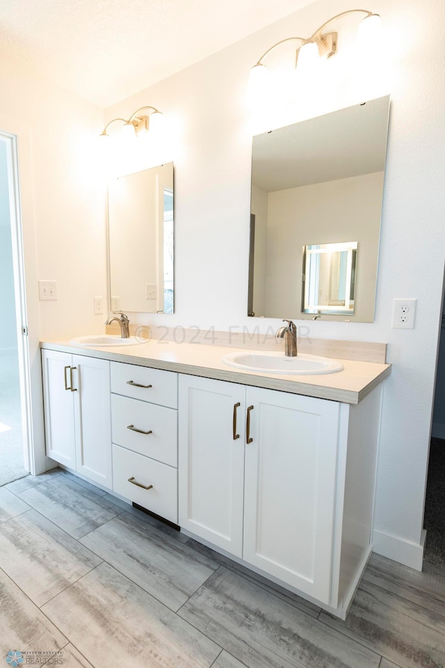 bathroom with hardwood / wood-style floors and double sink vanity