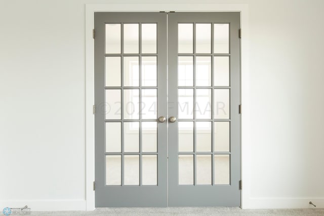 doorway to outside with french doors, carpet floors, and plenty of natural light