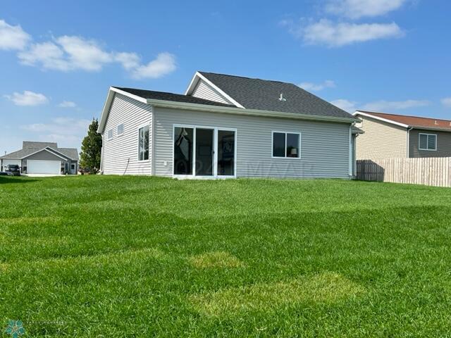 back of house featuring a yard