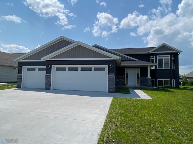 view of front of house with a garage and a front lawn