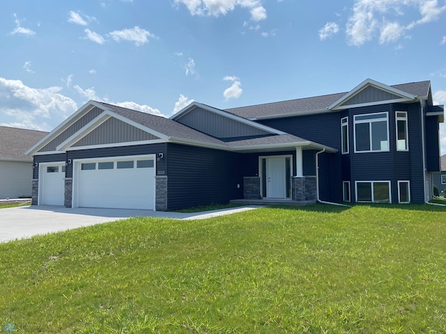 view of front of property with a garage and a front lawn