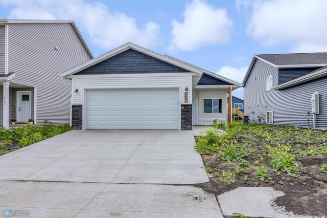 view of front of home featuring central air condition unit and a garage