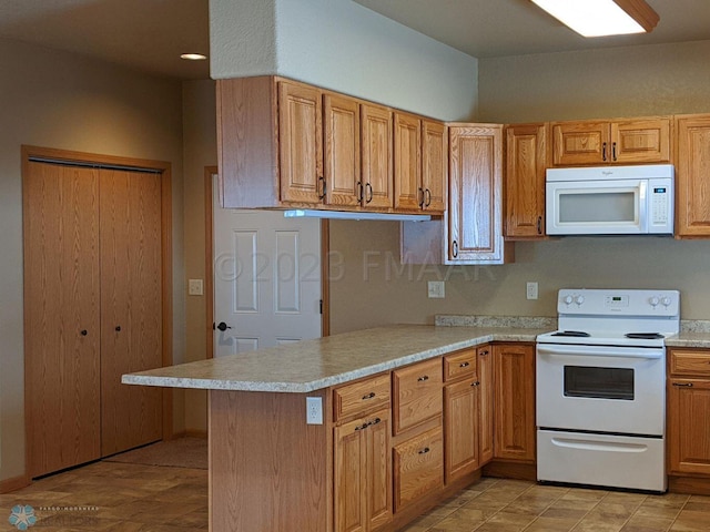 kitchen featuring white appliances, kitchen peninsula, and light tile floors