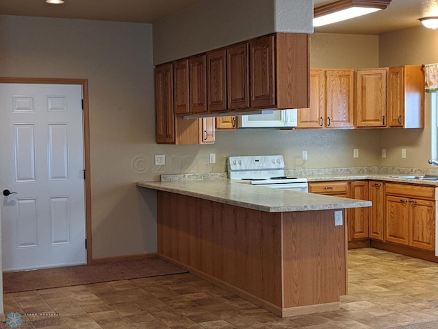 kitchen with sink, kitchen peninsula, white appliances, and light tile floors