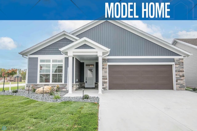 view of front of house with a front yard and a garage