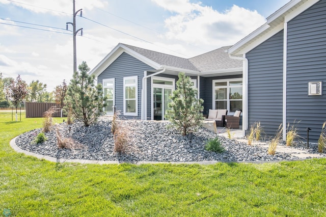 exterior space with an outdoor hangout area, a lawn, and a patio