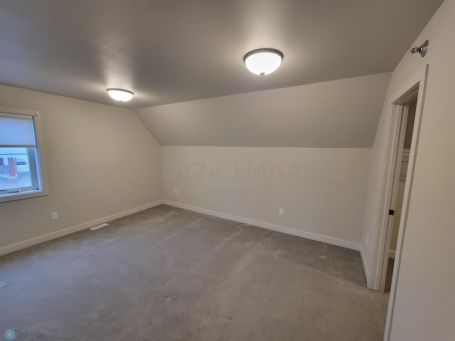 bonus room featuring carpet flooring and lofted ceiling