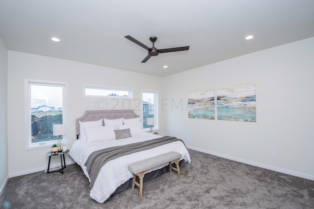 bedroom with dark colored carpet and ceiling fan