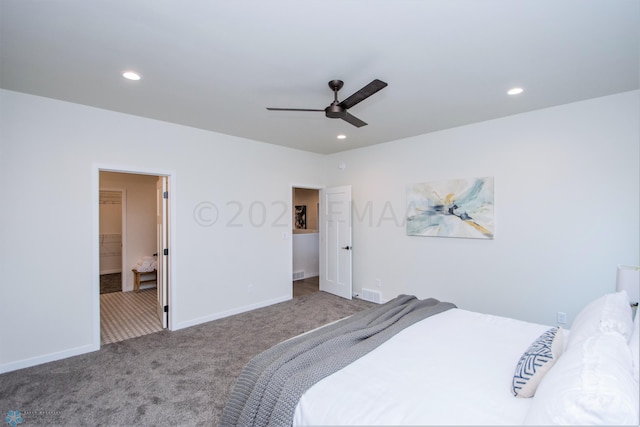 bedroom with a walk in closet, ceiling fan, and carpet flooring