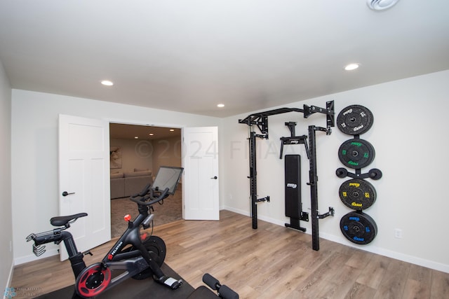 workout area featuring light wood-type flooring