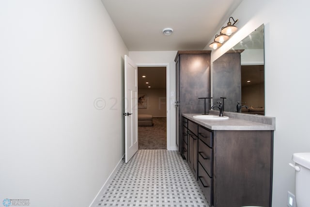 bathroom featuring vanity, toilet, and tile flooring