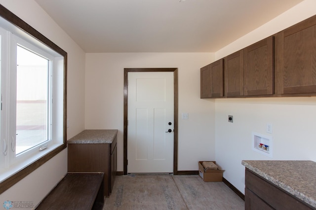 clothes washing area featuring electric dryer hookup, washer hookup, and cabinets