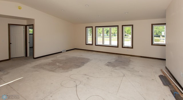 unfurnished room featuring lofted ceiling