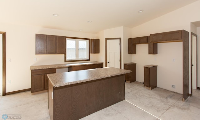 kitchen with a center island and lofted ceiling