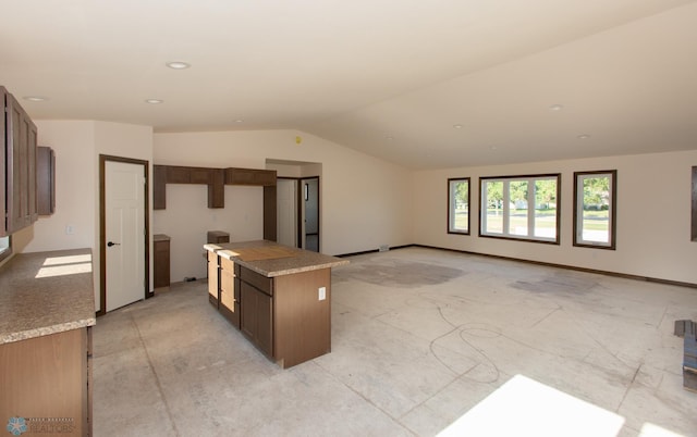 kitchen with a kitchen island and vaulted ceiling