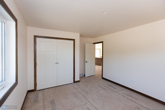 unfurnished bedroom with a closet