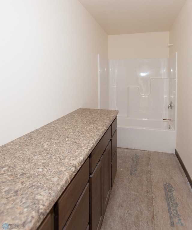 bathroom featuring tub / shower combination and vanity