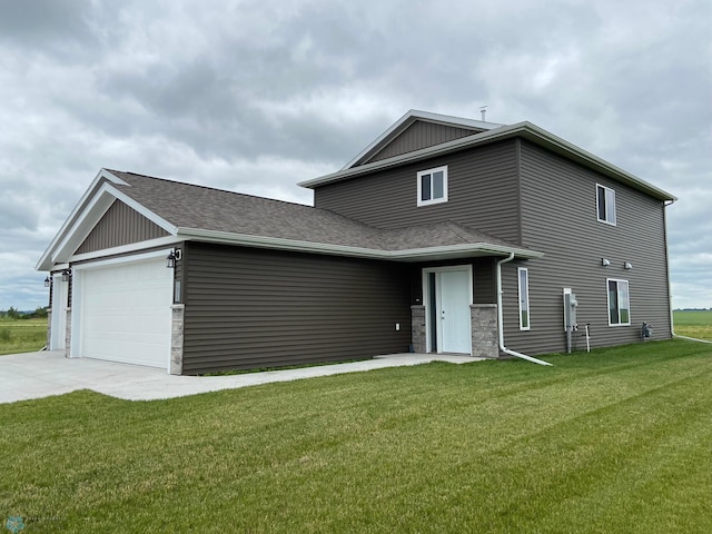 view of front of house with a front yard and a garage