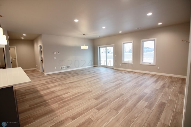 spare room featuring light hardwood / wood-style floors