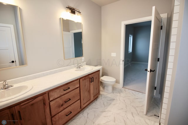 bathroom with double vanity, tile floors, and toilet