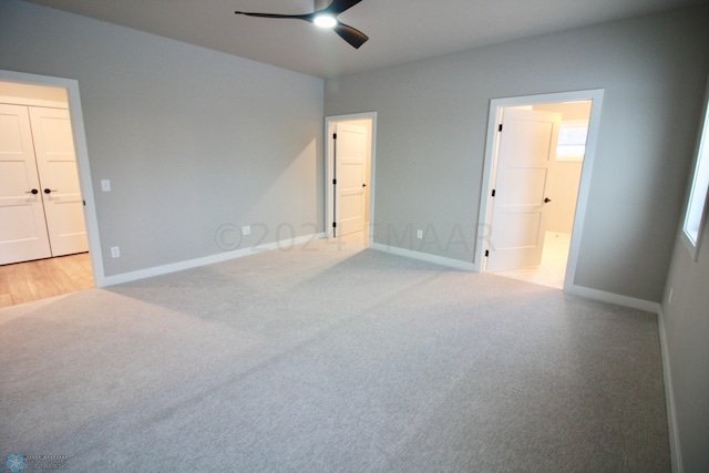 carpeted empty room featuring ceiling fan