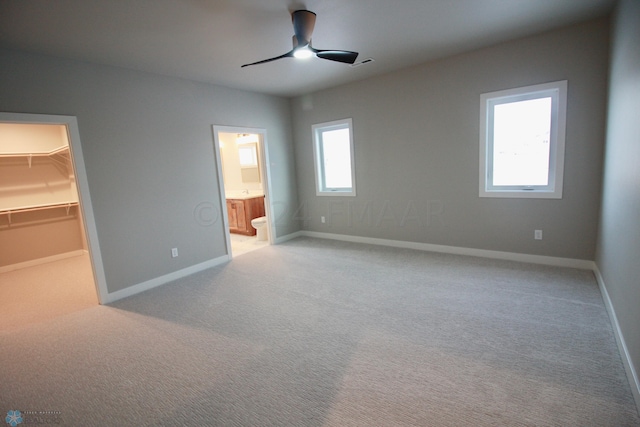 empty room with ceiling fan and carpet floors