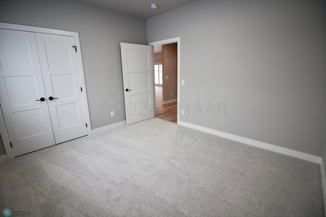 unfurnished bedroom with a closet and carpet floors