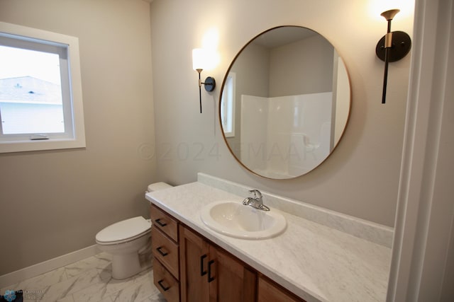 bathroom with tile floors, vanity, and toilet