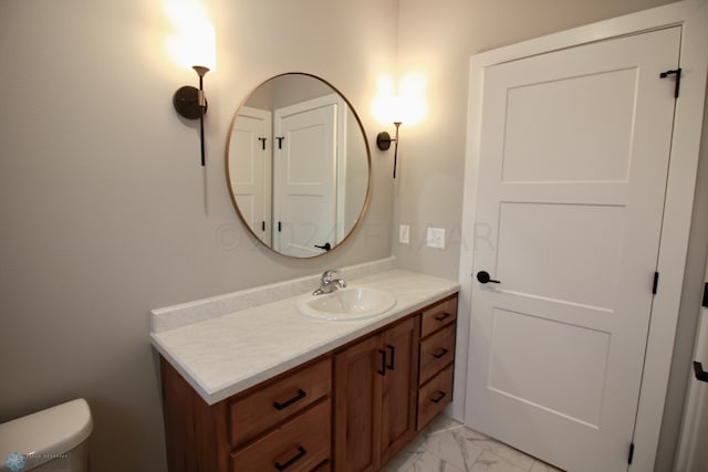 bathroom with toilet, oversized vanity, and tile flooring