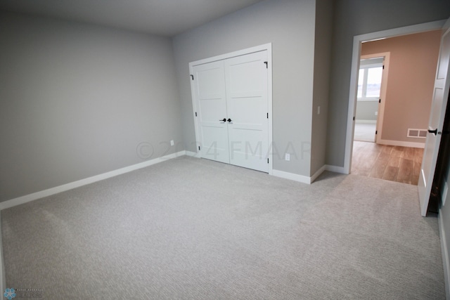 unfurnished bedroom with a closet and carpet flooring