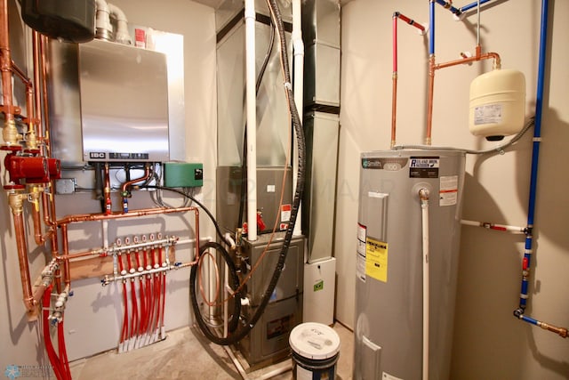 utility room with tankless water heater and water heater